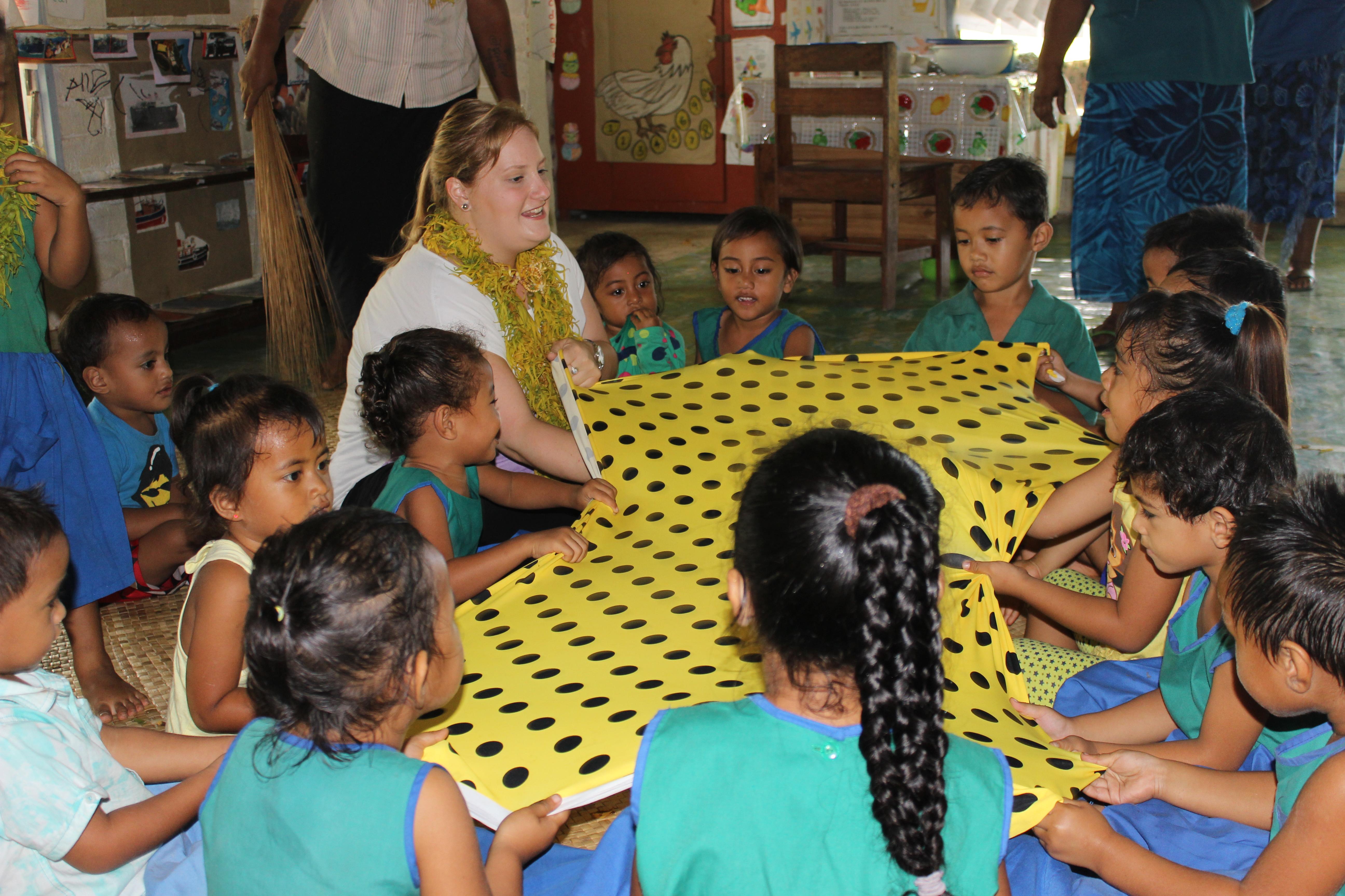 A Projects Abroad volunteer teaches at a local school during her cultural immersion in Samoa. A volunteer in a village in Samoa teaches a class at a local school.